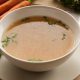 Bone broth made from chicken served in a bowl with parsley