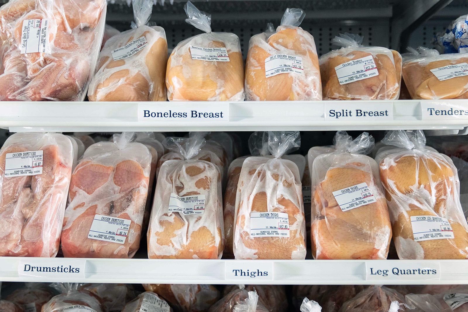 bulk chicken on freezer shelf in storefront